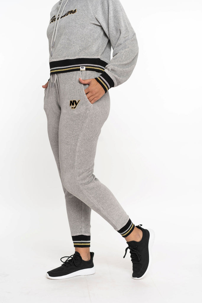 New York Islanders NY grey velor sweatpant with black, silver, and gold stripe on model