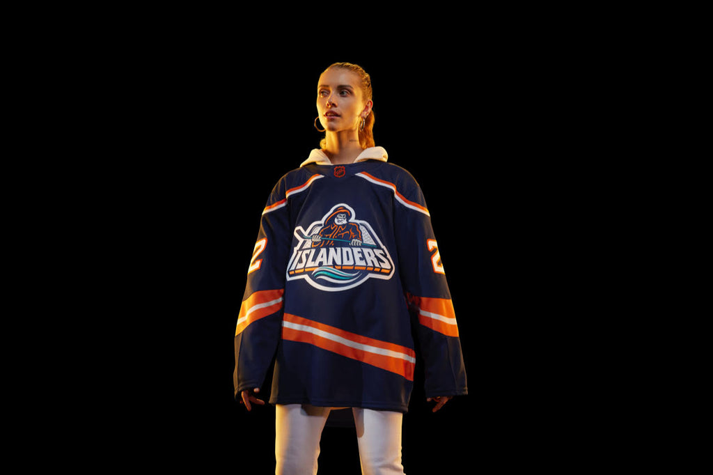On model New York Islanders Reverse Retro Navy Fisherman Jersey with orange and white stripes made by adidas