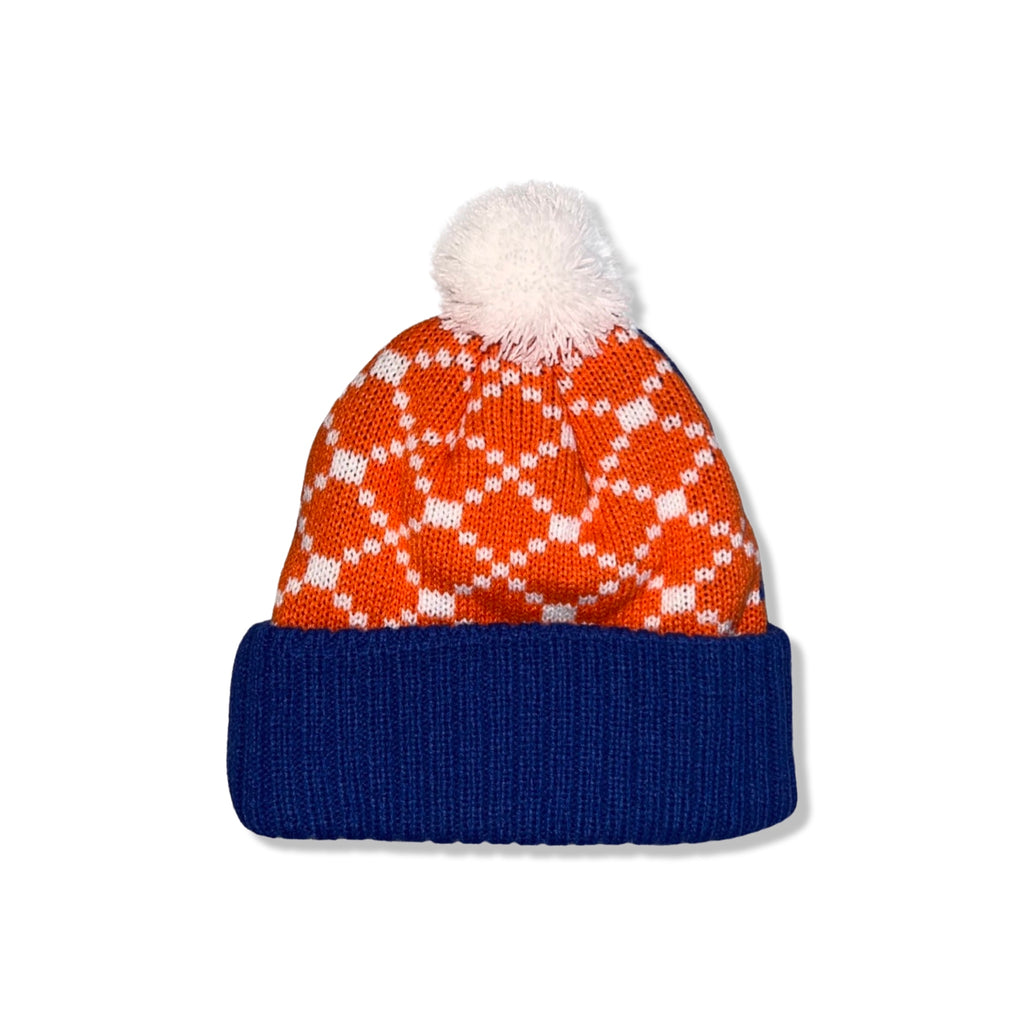 The back of a blue beanie with NY Islanders logo, orange plaid design, and white pom on top.