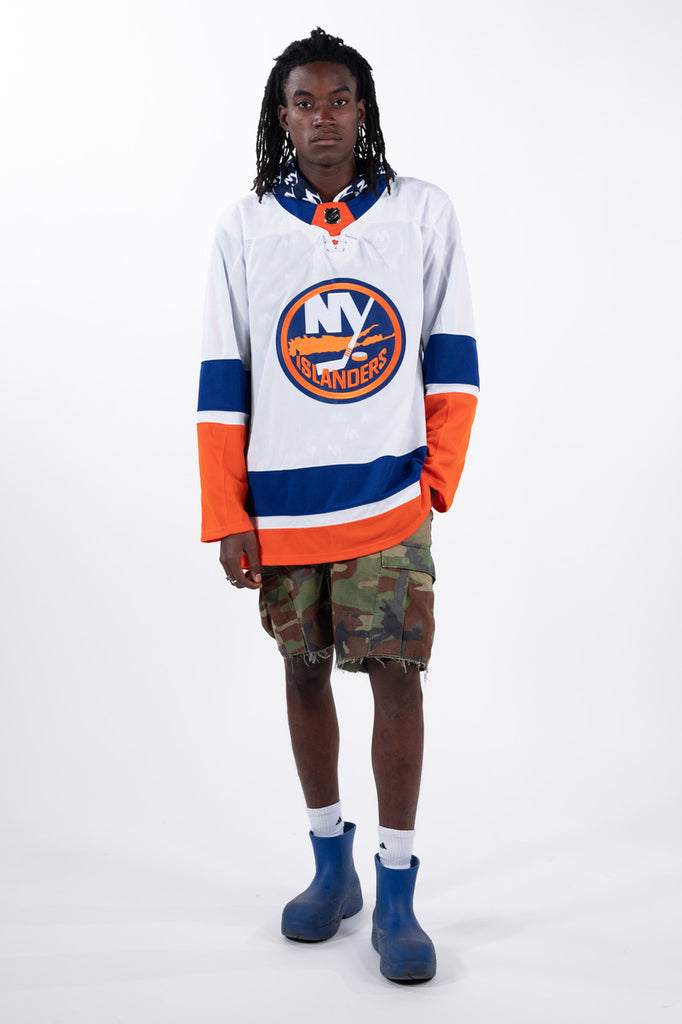 On Model New York Islanders white away primary jersey with blue and orange stripe made by adidas